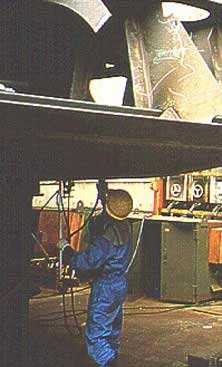 	Worker grinding material overhead