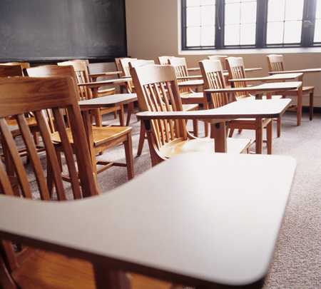 Empty desks in a school classroom.