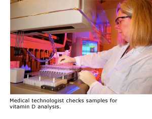 Medical technologist checks samples for vitamin D analysis.