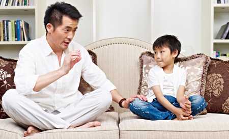 Parent talking to child on couch