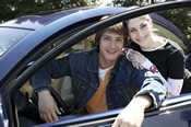 photo: teenage boy and girl with a car