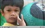 Video still of a young boy with a ball