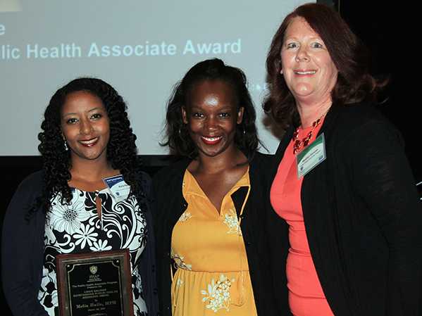 Melia Haile (left) receiving the 2017 Louis Salinas Outstanding Public Health Associate Award for her exemplary work in public health from her CDC supervisor, Shannon White (middle), and PHAP Director Heather Duncan (right).