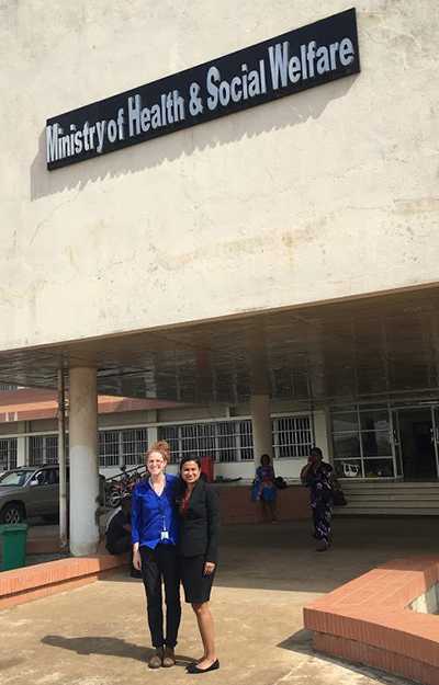 	Akshara Menon and Emily standing in front of the Liberian Ministry of Health.