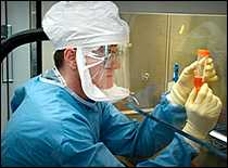 Scientist in protective gear working in a laboratory