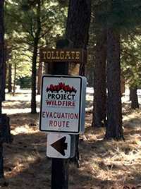 Project Wildfire Evacuation sign posted in the Tollgate community.