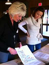 Tollgate Business Manager, Betty Fadeley, showing Cori Wigington the residence map of homes at risk for fire damage and/or those requiring extra assistance in case of an emergency.