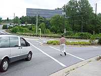 photo of man walking in crosswalk