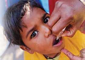 Photo of young boy receiving the oral polio vaccine