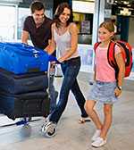 Family carting luggage