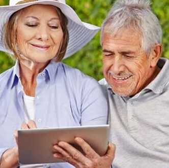 Older couple looking over a touchscreen