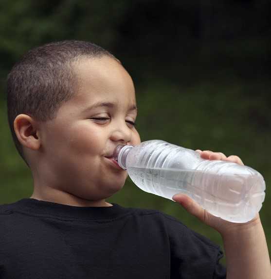 Image of a boy drinking a bottle of water