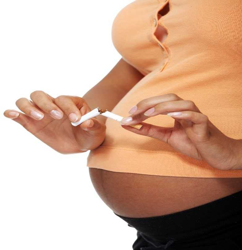 Image of a pregnant woman breaking a cigarette in half