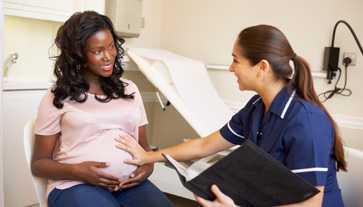 Photo of expectant mother talking to her nurse