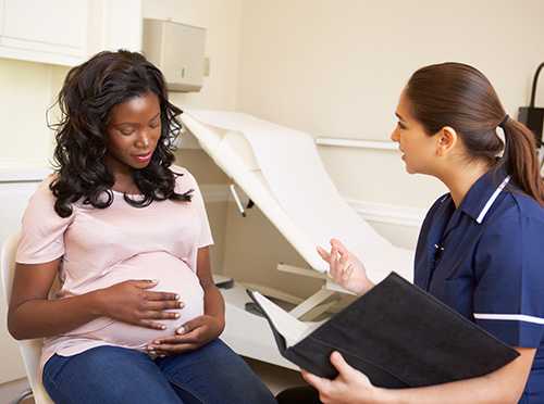 A pregnant woman being given information about pregnancy