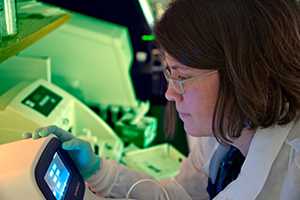 Microbiologist loading bacterial DNA into Next Generation Sequencing technology.* 
