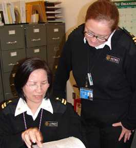 Two public health officers looking over a document.