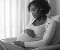 image of young pregnant woman sitting in a chair