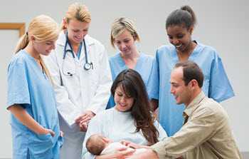 image of a team of doctors with parents holding their infant