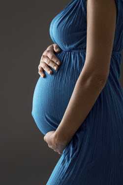 image of a pregnant woman holding her bely