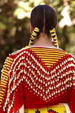 The back of a native american woman in costume