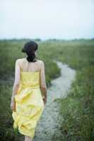 image of a woman walking away on a path