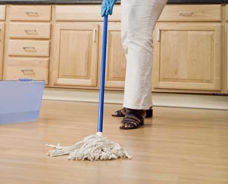 Person mopping floor with disinfectant
