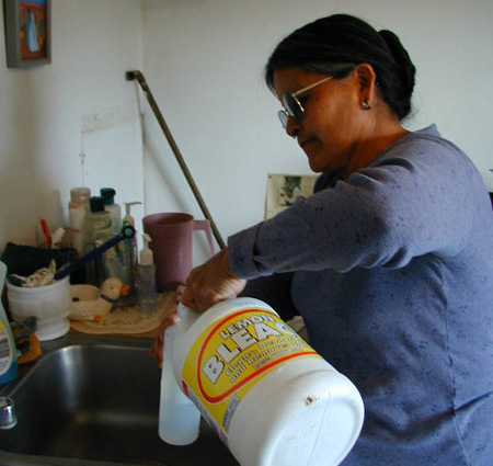 Woman mixing bleach and water