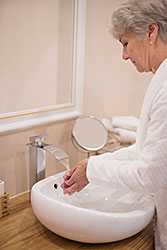 Senior woman washing her hands