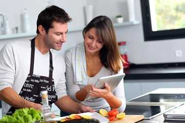 Couple cooking together in the kitchen.