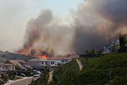 Un incendio forestal cercano a unas casas