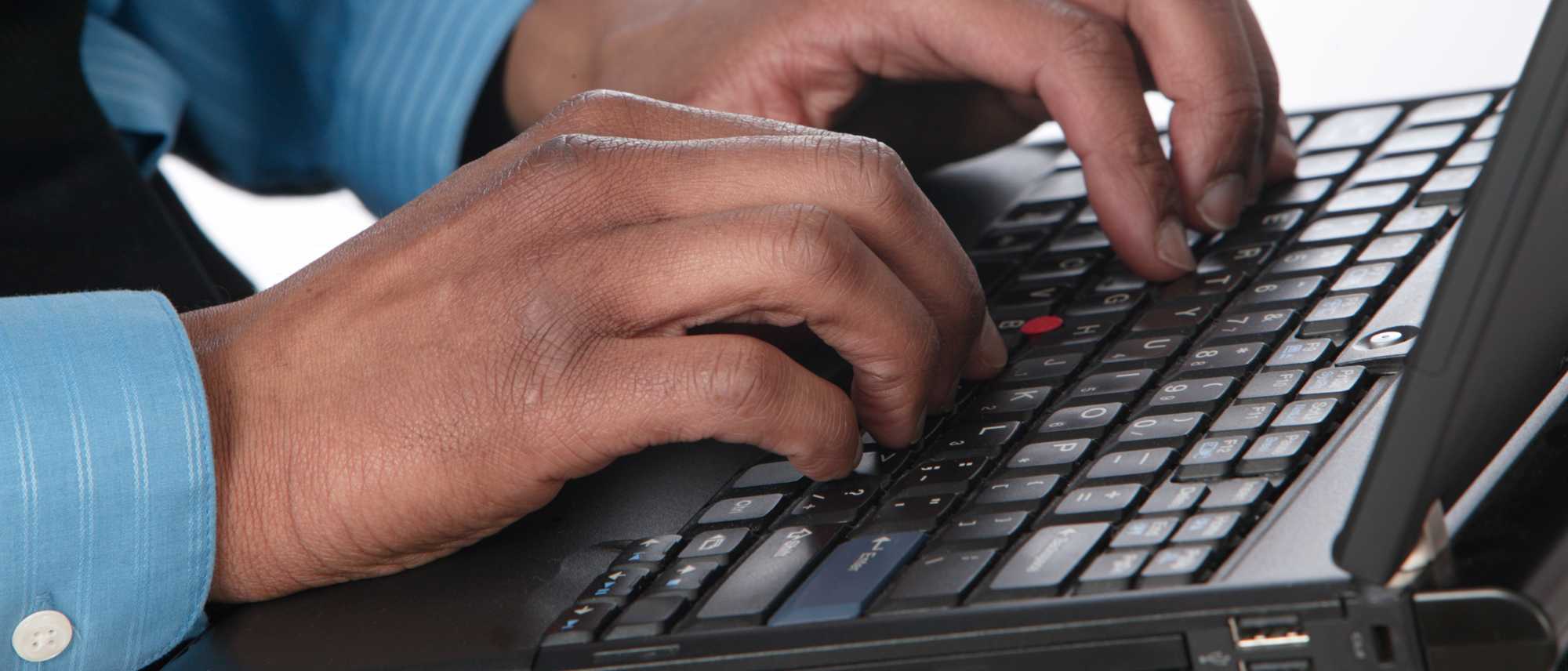man typing on keyboard