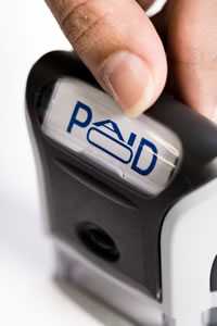 Image of a stamping device with the word "Paid"