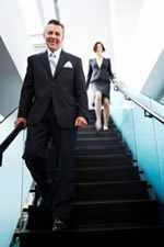 Business man and woman walking down stairs