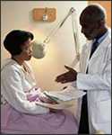 Photograph of a doctor speaking with a patient