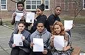 Students pose with the letters they received from CDC volunteers working to fight Ebola