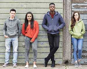 Teens standing against wall