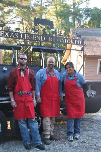 The crew from TEXAS LEGEND BBQ are getting ready to serve the Watsonians; pictured left to right are Eric, John Richardson (owner and Chef of Texas Legend BBQ), and Rose