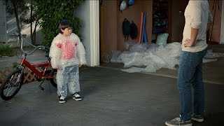 Boy with bubble wrap covering body