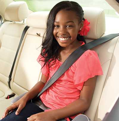 Pre-teen in the backseat wearing her seatbelt