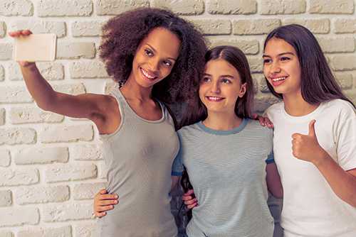 Three teen girls taking a selfie