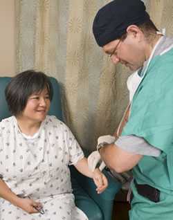 woman patient having pulse rate checked by medical professional