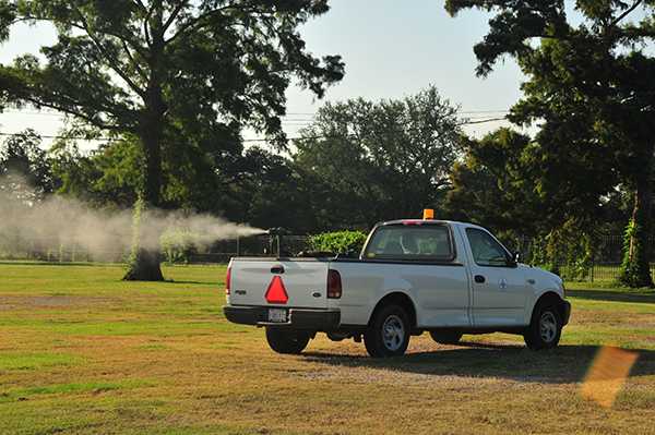 A pickup truck spraying insecticide